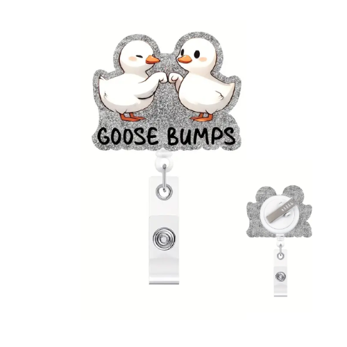 Two cartoon ducks with 'GOOSE BUMPS' text on a gray background, featuring a clip-on badge holder.