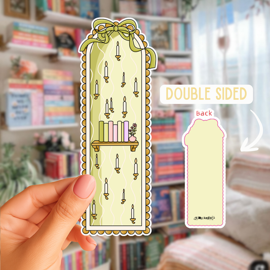 Double-sided decorative bookmark held in front of a bookshelf