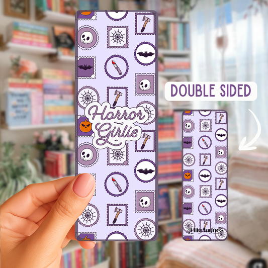Double-sided phone case with 'Horror Girlie' design held by a hand in a room with books and decor.