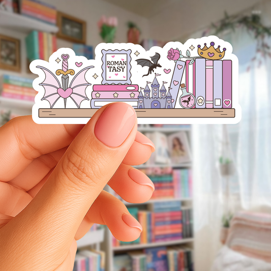 Hand holding a sticker with various illustrations including books, a castle, and a sword in a room with bookshelves.