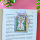 Decorative key and bow bookmark on a book with a pink background