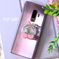 Phone case with cherry design and 'POP GRIP' text on a light purple background