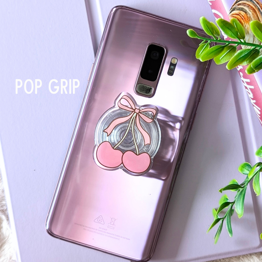 Phone case with cherry design and 'POP GRIP' text on a light purple background