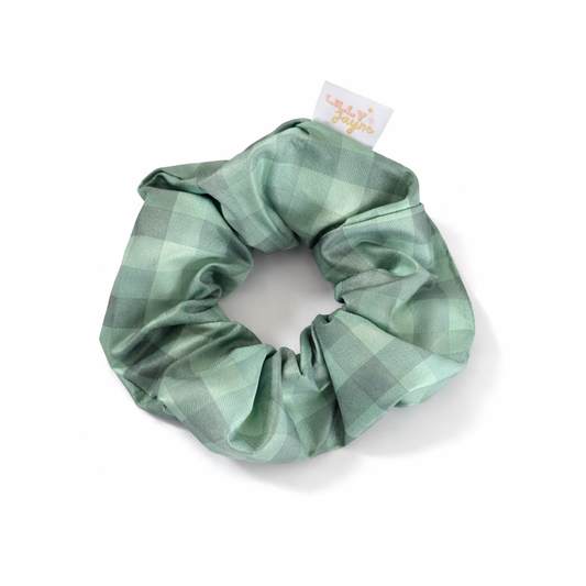Green checkered scrunchie with a brand tag on a white background