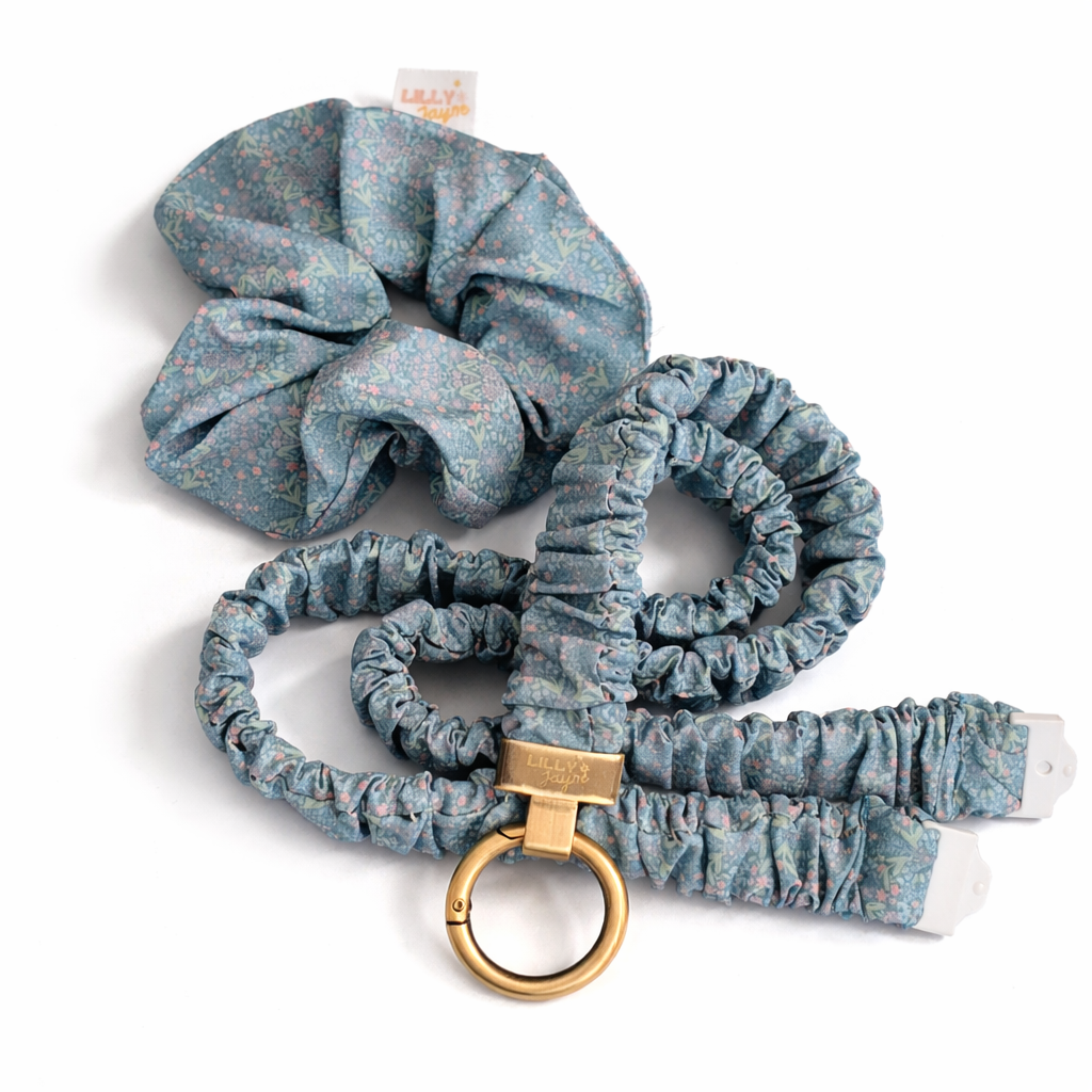 Set of blue scrunchies with a leash and gold clip on a white background