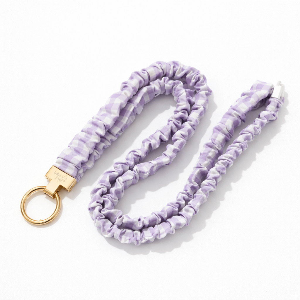 Lavender tie-dye keychain with gold clasp on a white background