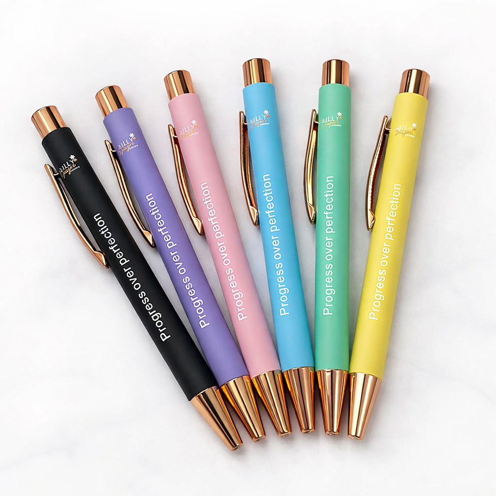 Set of colorful pens with rose gold accents on a white background