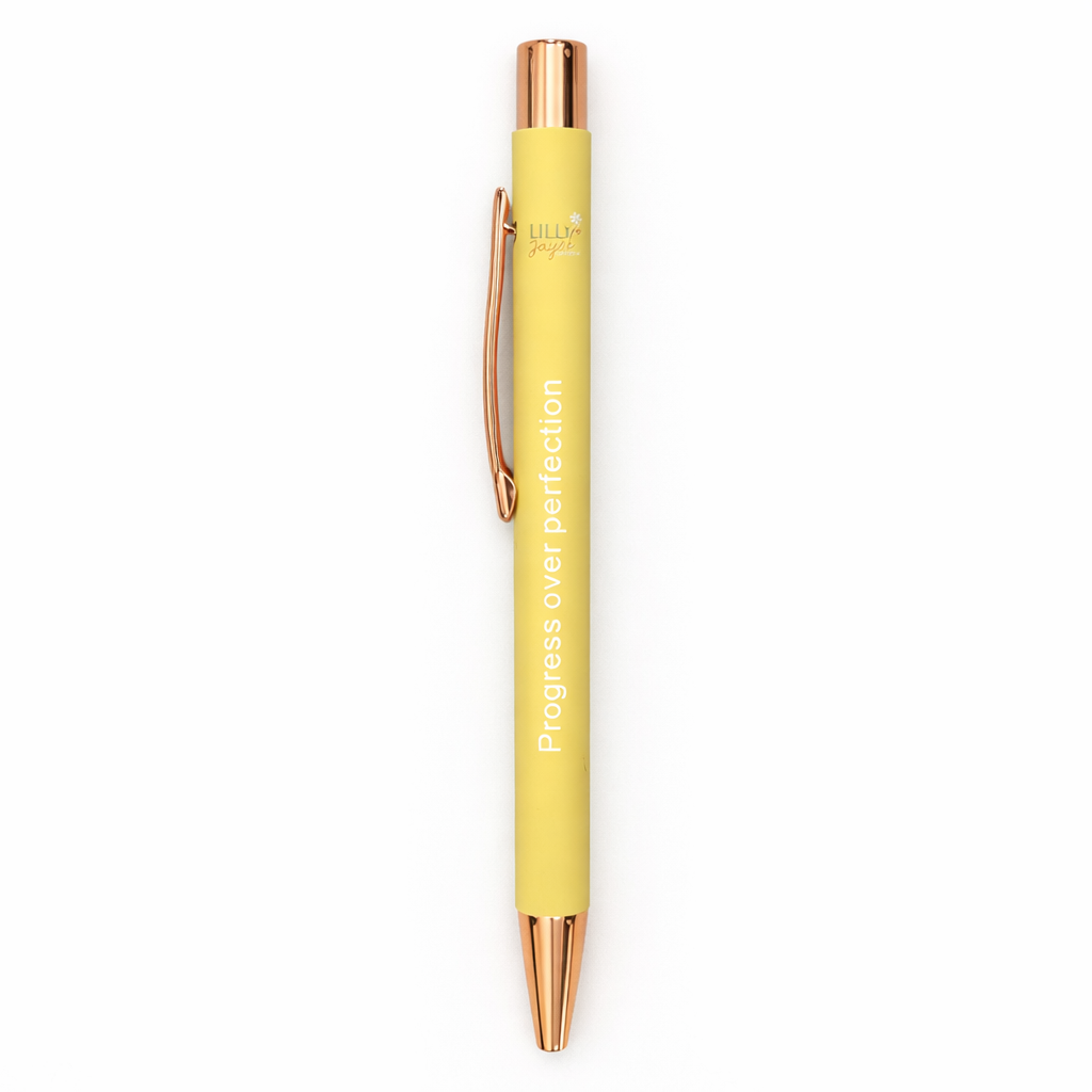 Yellow pen with rose gold accents on a white background