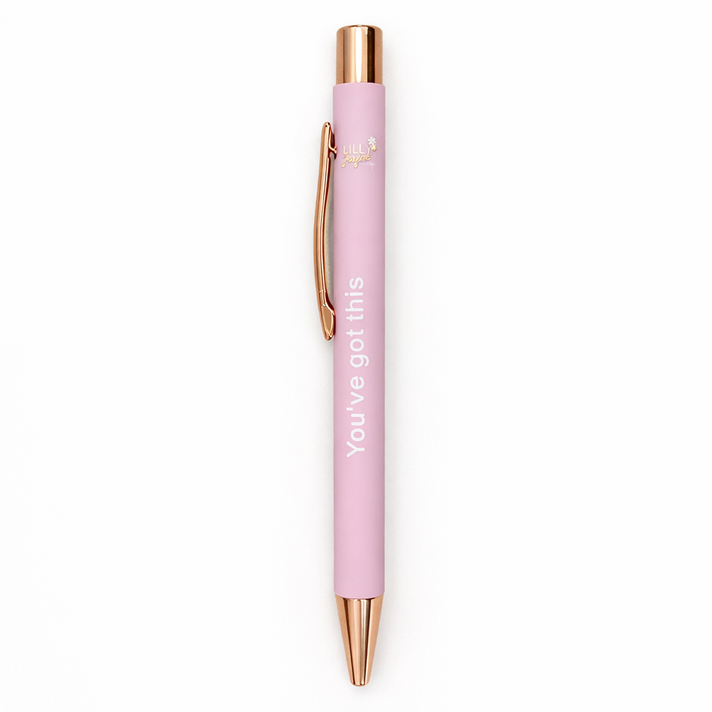 Pink pen with rose gold accents on a white background