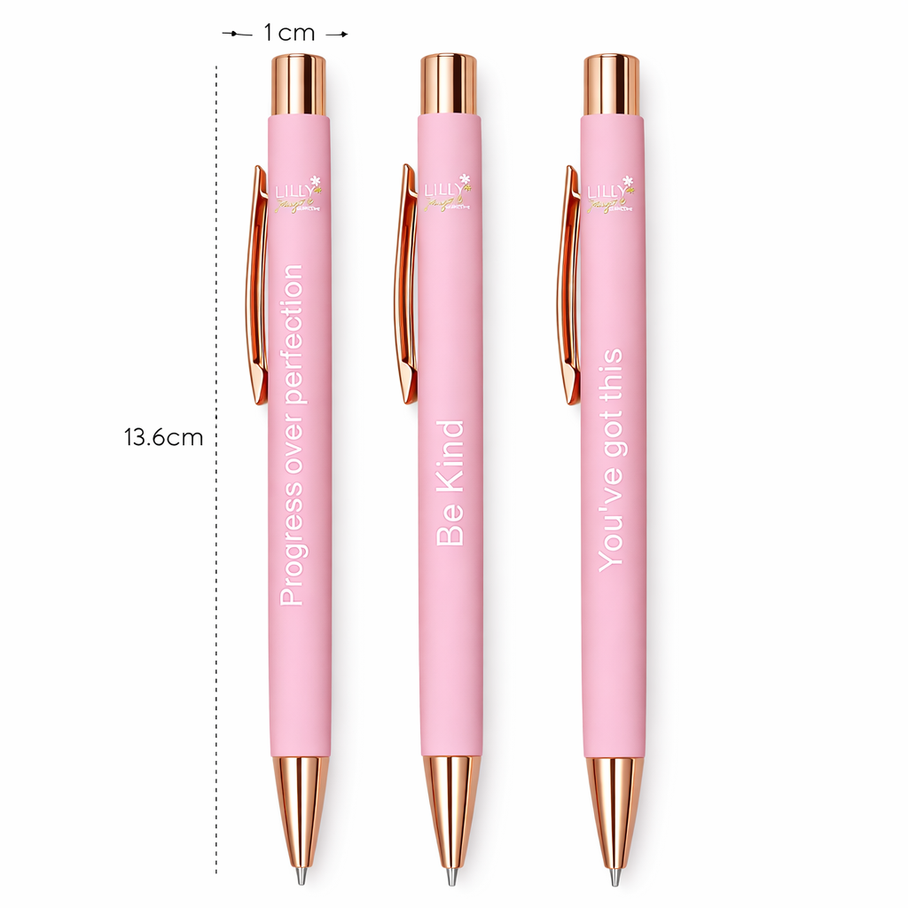 Three pink pens with rose gold accents and motivational phrases, shown with a measurement scale.