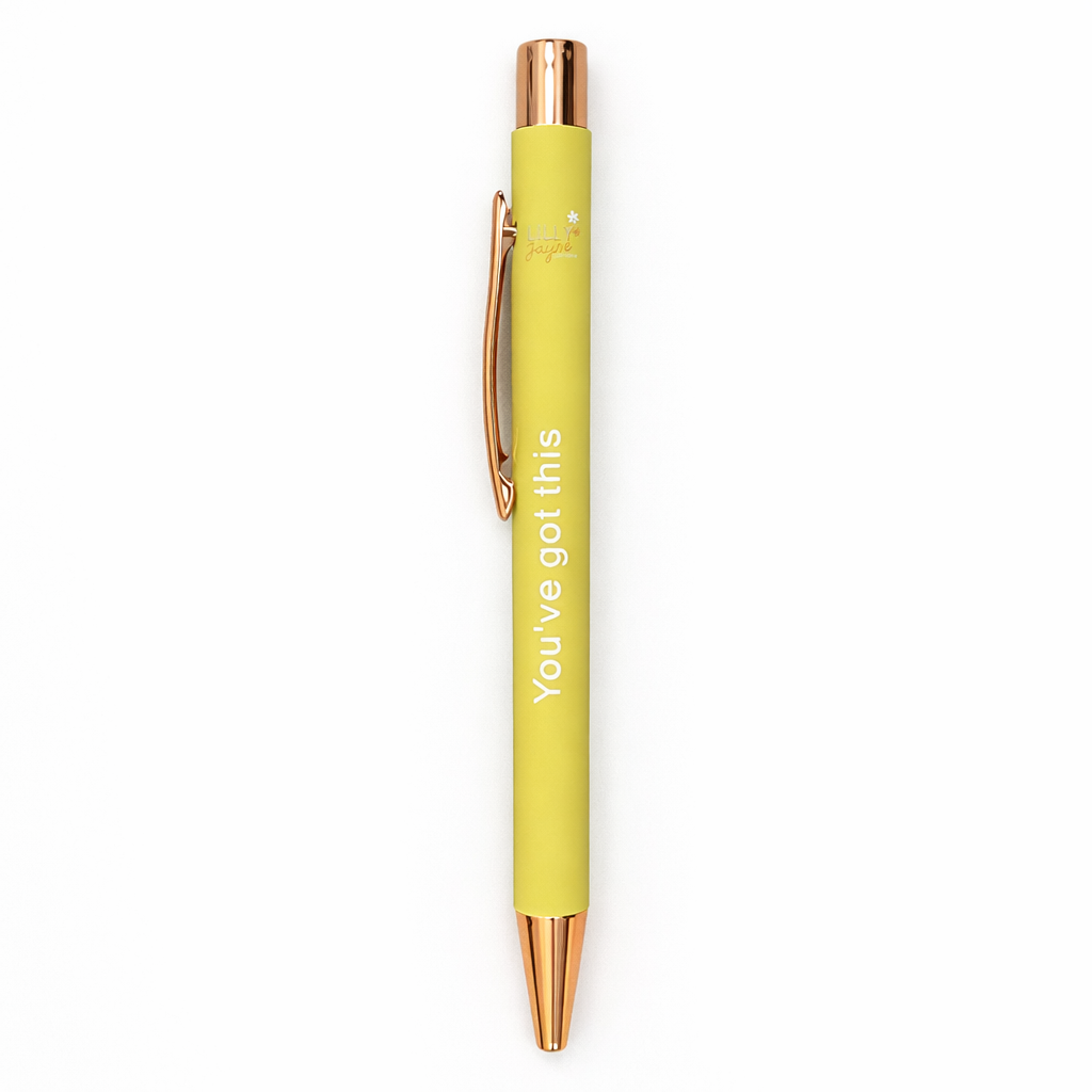 Yellow pen with rose gold accents on a white background