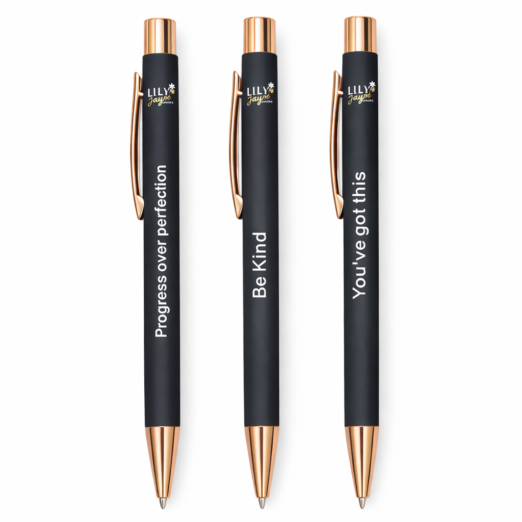 Three black pens with rose gold accents and motivational quotes on a white background