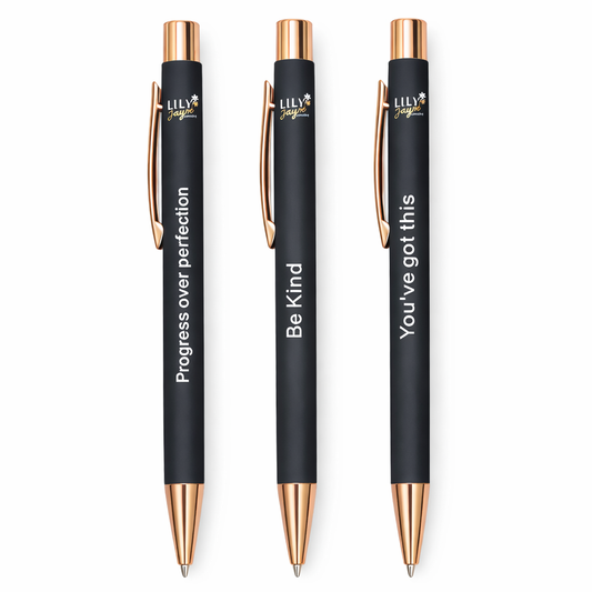 Three black pens with rose gold accents and motivational quotes on a white background