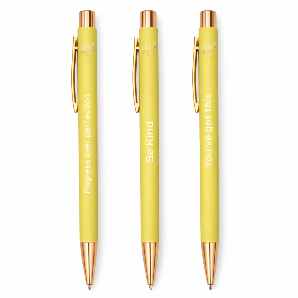 Three yellow pens with rose gold accents on a white background