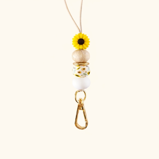 Necklace with floral pendant and wooden beads on a white background