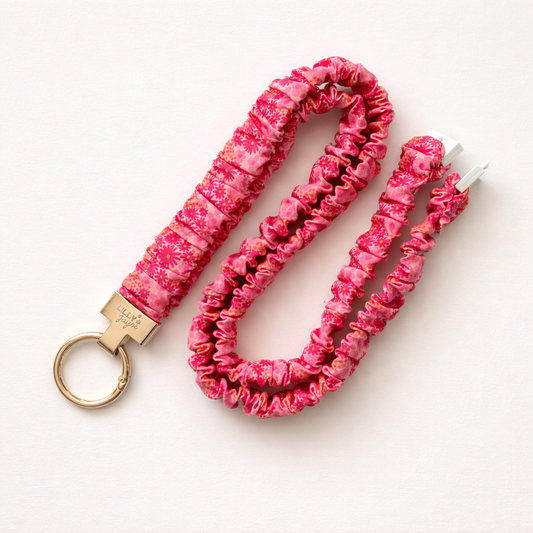 Pink scrunchie keychain and lanyard on a white background