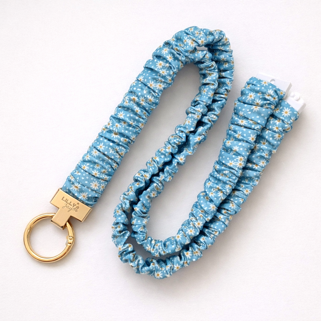 Blue floral-patterned keychain with gold ring on a white background