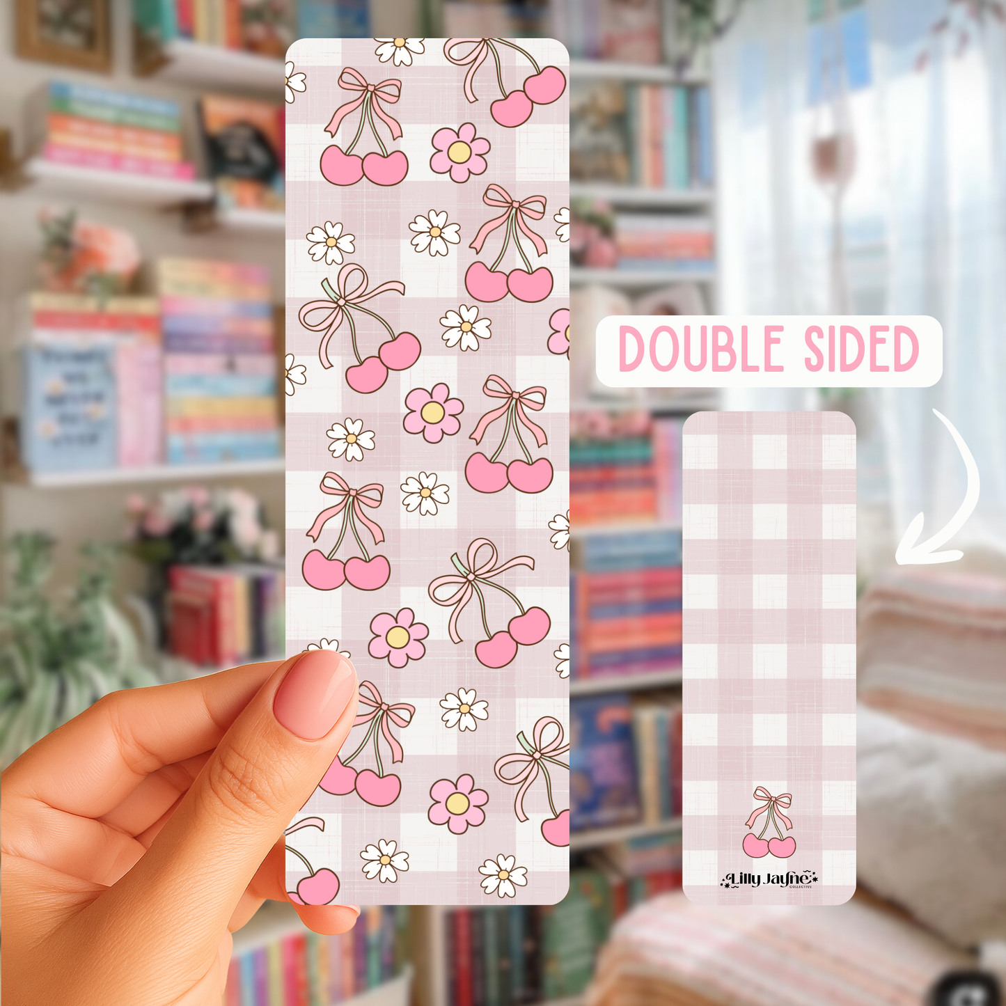 Double-sided decorative paper with cherry and bow pattern held by a hand in a room with books and decor.