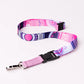 Pink and purple patterned lanyard with a black clip on a white background