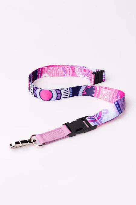 Pink and purple patterned lanyard with a black clip on a white background