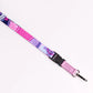 Pink and purple patterned lanyard with a keychain attachment on a white background