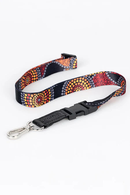 Colorful patterned lanyard with a black clip on a white background