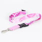 Pink and white patterned lanyard with a black clip on a white background