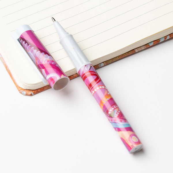 Two colorful pens on a notebook with a white background