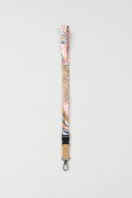 Floral patterned lanyard with wooden accent on a light gray background