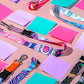 Colorful lanyards and sticky notes on a pink background