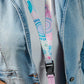 Person wearing a colorful lanyard with a denim jacket and white shirt.