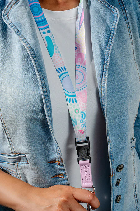 Person wearing a colorful lanyard with a denim jacket and white shirt.