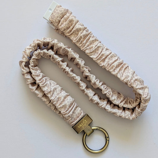 Floral-patterned lanyard with keychain on a white background