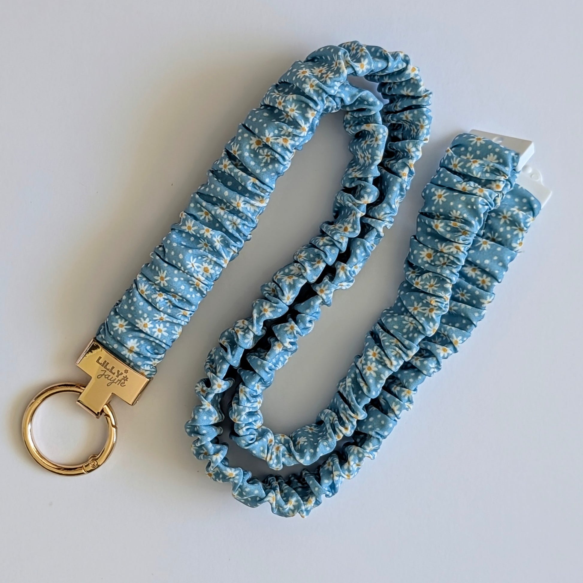 Blue floral scrunchie keychain on a white background