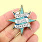 Star-shaped pin with 'Proudly Neuro-Sparkly' text held in a hand against a yellow background