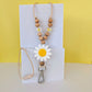 White Flower Beaded Lanyard. Large White Flower silicone bead with yellow centre. Wooden beads and acrylic flower bead. with a silver clip