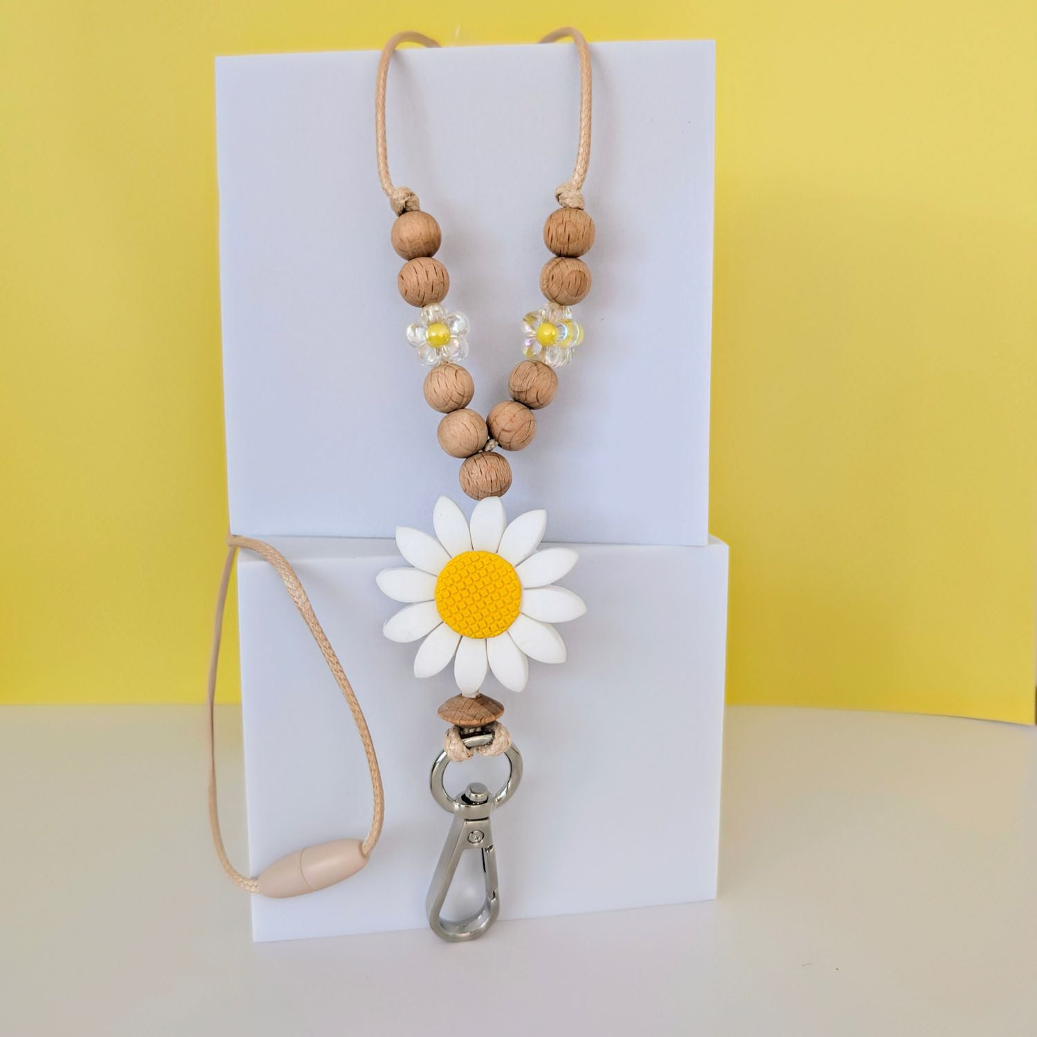 White Flower Beaded Lanyard. Large White Flower silicone bead with yellow centre. Wooden beads and acrylic flower bead. with a silver clip