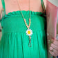 Woman wearing the white flower lanyard with a white with yellow centre flower with Silicone Bead Sunflower Lanyard Wooden round beads with Silver Clip and Breakaway Clasp.