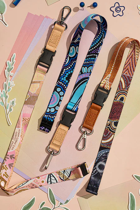 Three colorful lanyards with patterned designs on a pastel background