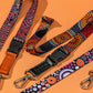 Three colorful lanyards with patterned designs on an orange background