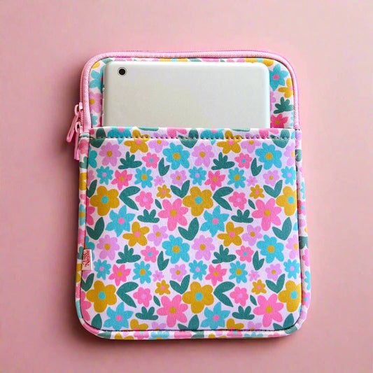 Floral patterned pouch with a pink zipper on a pink background