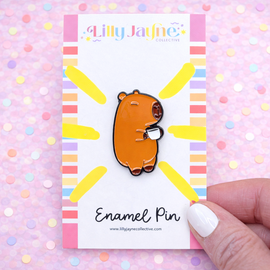 Lilly Jayne Collective enamel pin on a colorful background