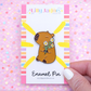 Enamel pin packaging with a bear design on a colorful background