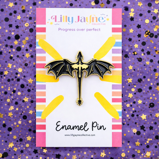 Lilly Jayne enamel pin on a colorful card with a purple background
