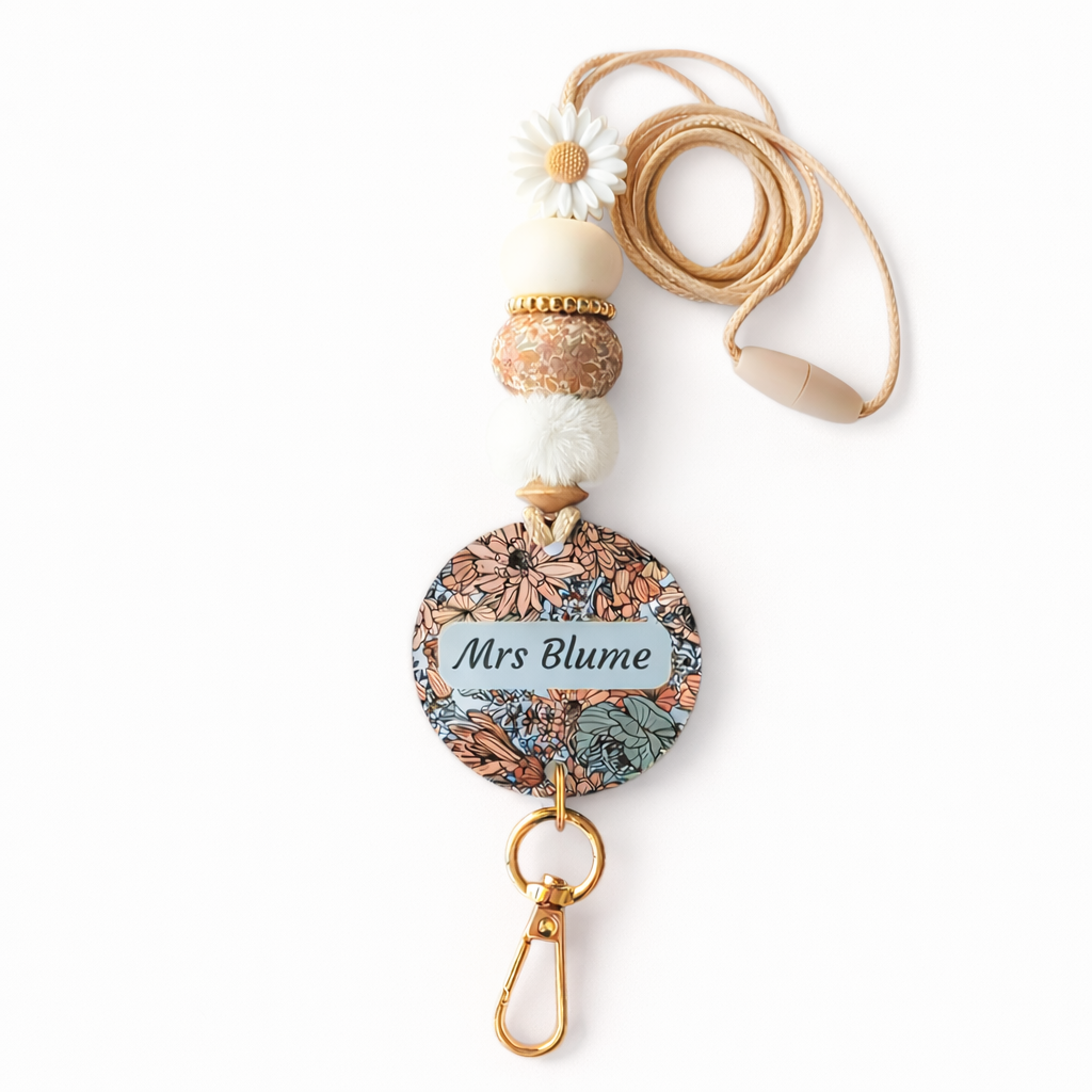 Decorative lanyard with floral design and 'Mrs Blume' text on a white background