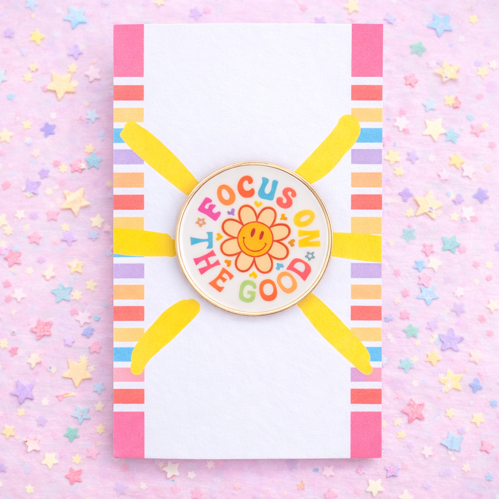Colorful badge with 'Focus on the Good' text on a pink background with stars