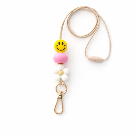 Phone lanyard with a smiley face bead on a white background