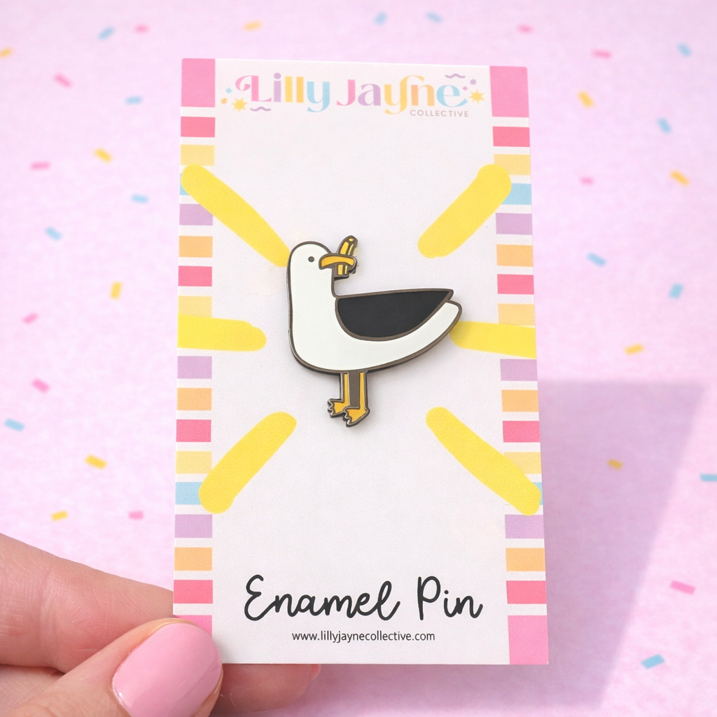 Enamel pin on a card with 'Lilly Jayne' branding against a colorful background