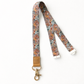 Floral patterned lanyard with a leather tag on a white background