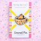 Enamel pin of a dog in a coffee cup on a colorful background with 'Lilly Jayne' branding.